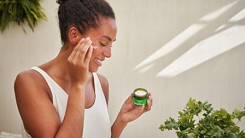 Woman using skinfood face care on her face