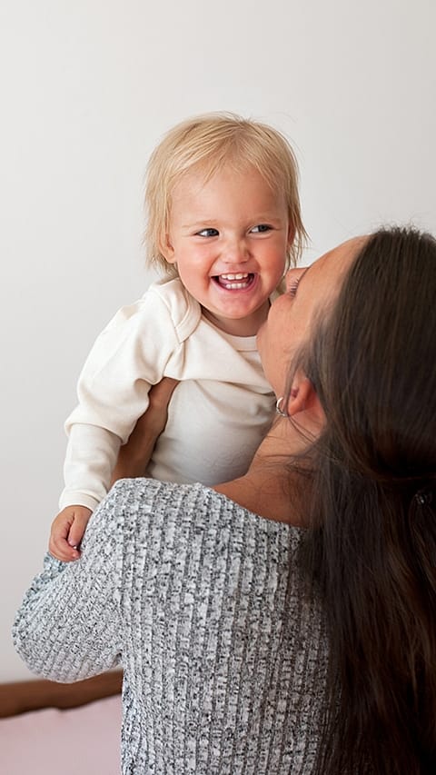 smiling-child-with-mother.jpg