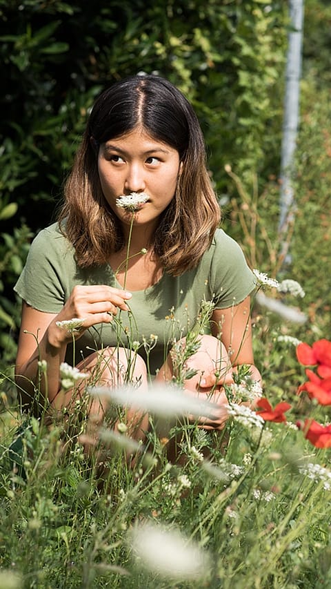 girl_smells_white_flower