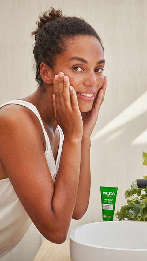 woman-washing-her-face-with-skinfood-in-background.jpg