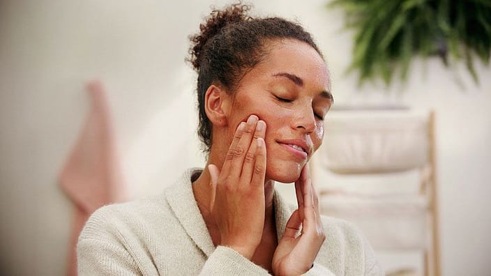 Woman cleaning her face in the bathroom