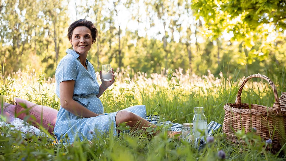 Pregnant  woman sitting in the grass