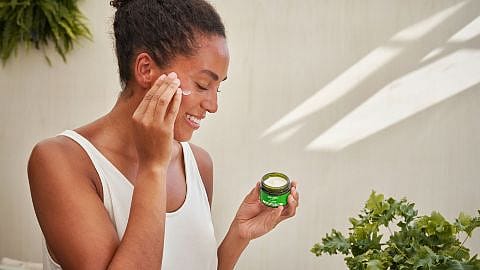 Woman using skinfood face care on her face