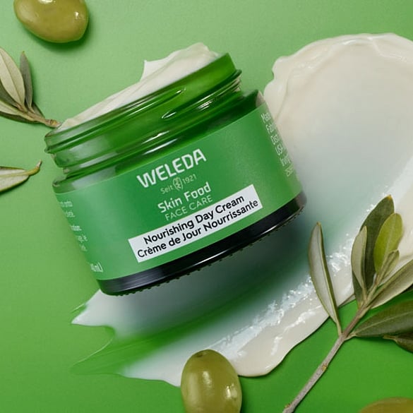 Skinfood day cream with olives on green background