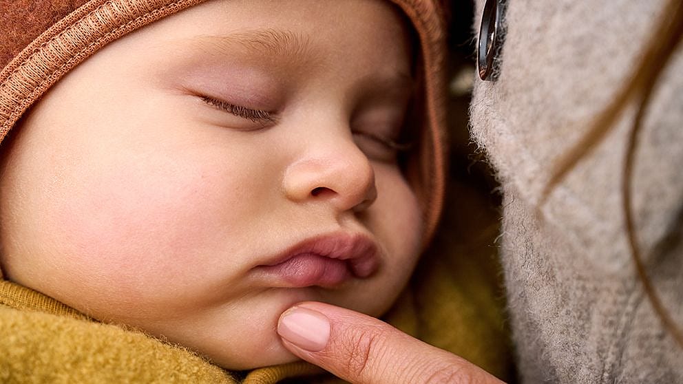 sleeping-baby-with-moms-finger