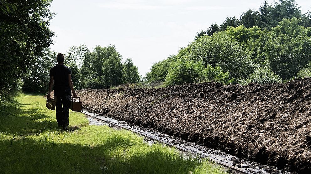 gardener_walking_next_to_compost.jpg