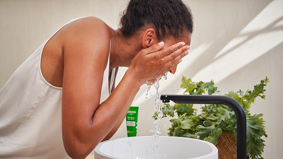 woman rinsing face